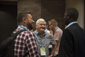 Three people talking at the partner meeting