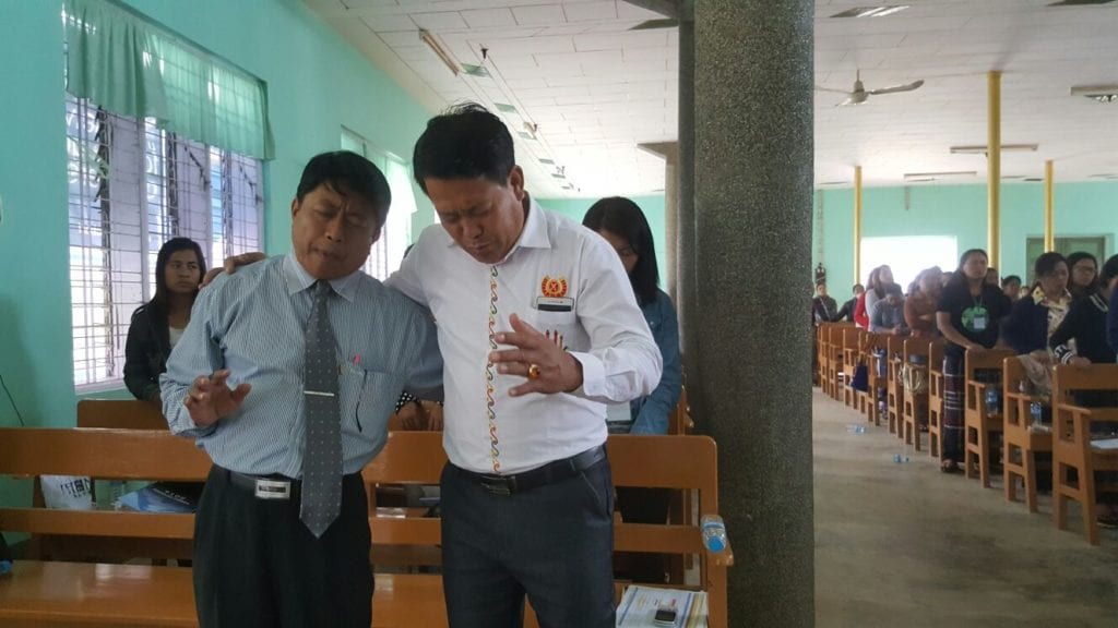 Men praying at the GLS in Myanmar