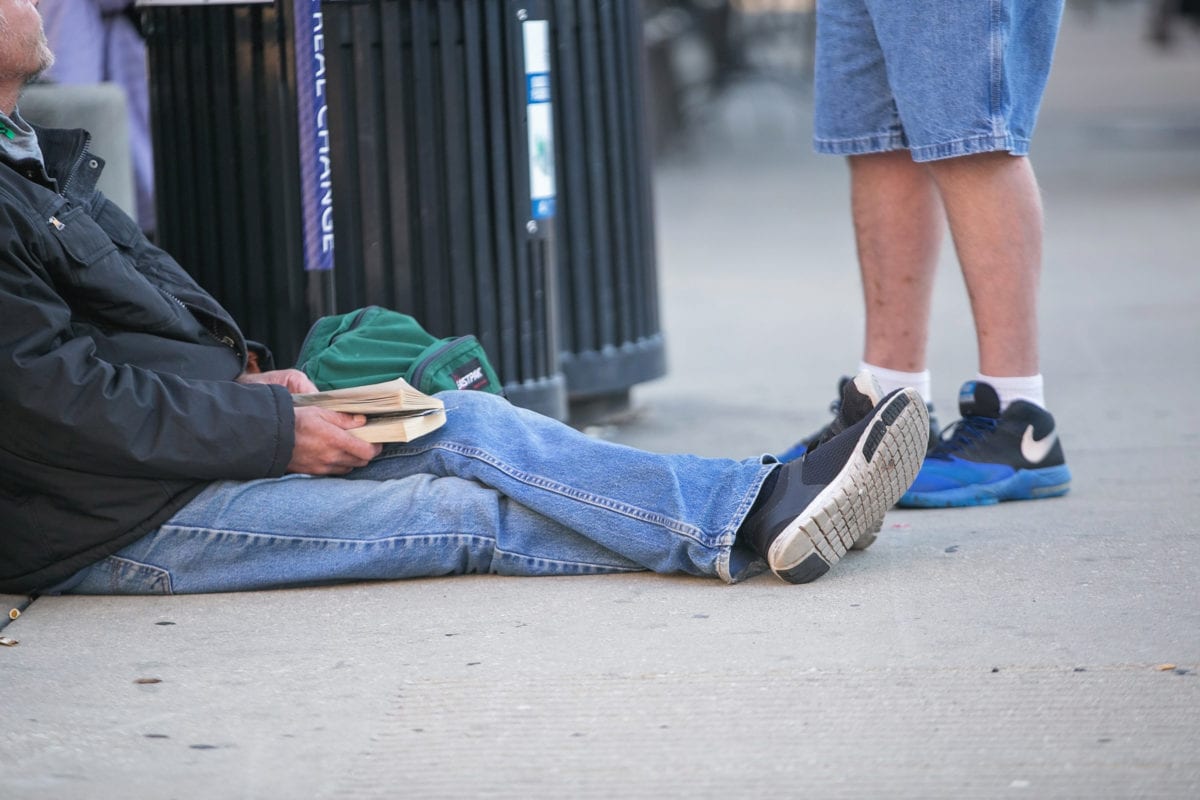 Homeless man sitting on the street