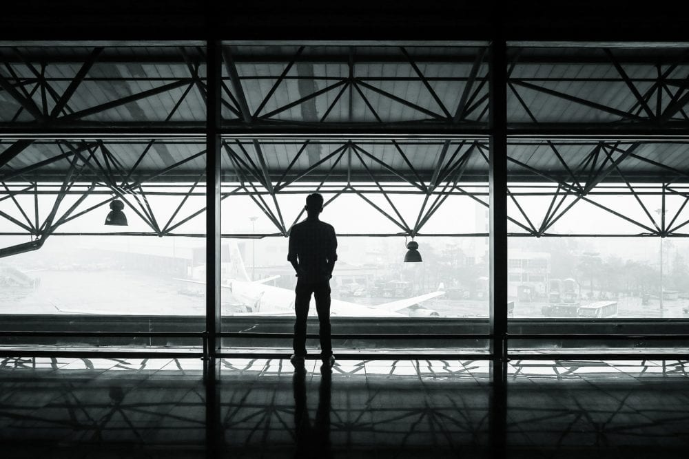Man standing in front of a large window