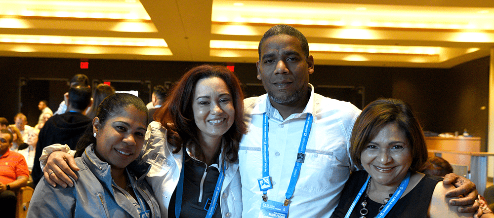 Four Summit Attendees smile for a posed shot during the two day event.