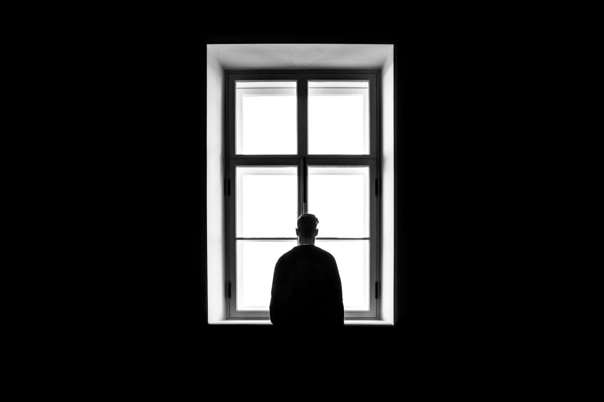 Man in front of window